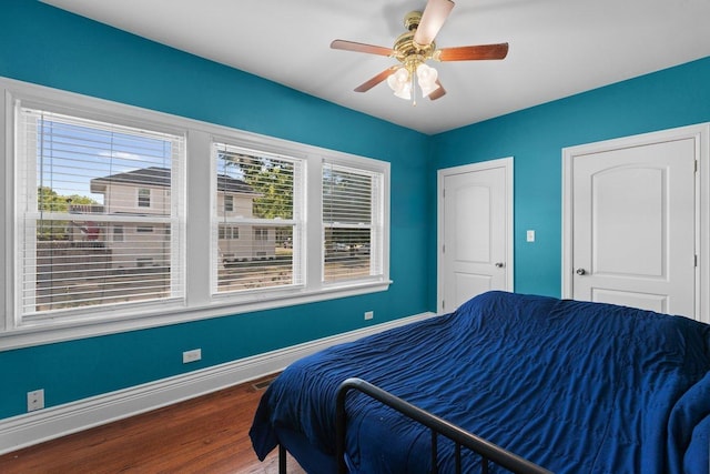 bedroom with ceiling fan and wood-type flooring