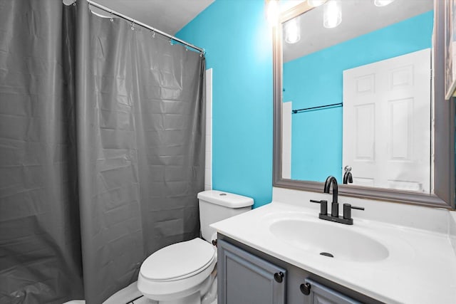 bathroom featuring vanity, toilet, and a shower with shower curtain