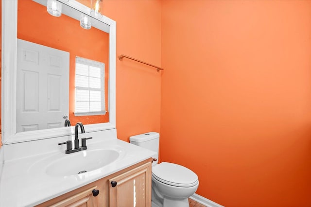 bathroom featuring vanity and toilet