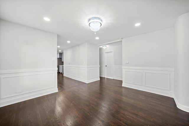 unfurnished room with dark wood-type flooring