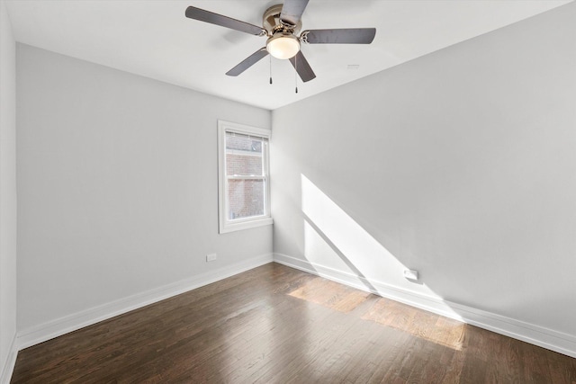 empty room featuring ceiling fan and dark hardwood / wood-style flooring