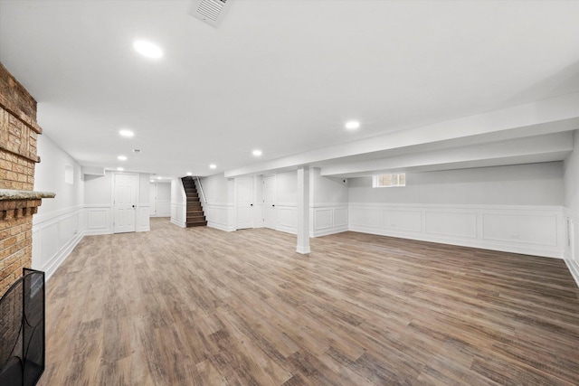 basement featuring a fireplace and hardwood / wood-style floors