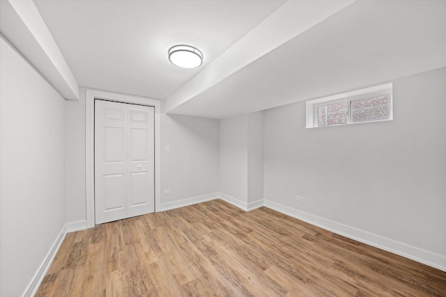 basement with light hardwood / wood-style floors