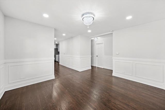 unfurnished room with dark wood-type flooring