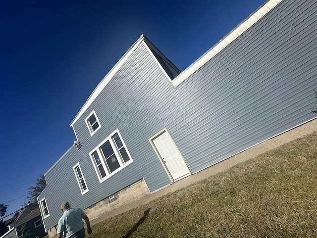 view of side of home with a lawn