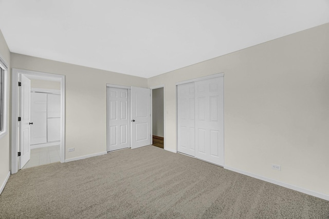 unfurnished bedroom with connected bathroom and carpet