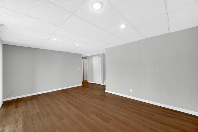 basement featuring hardwood / wood-style flooring and a paneled ceiling