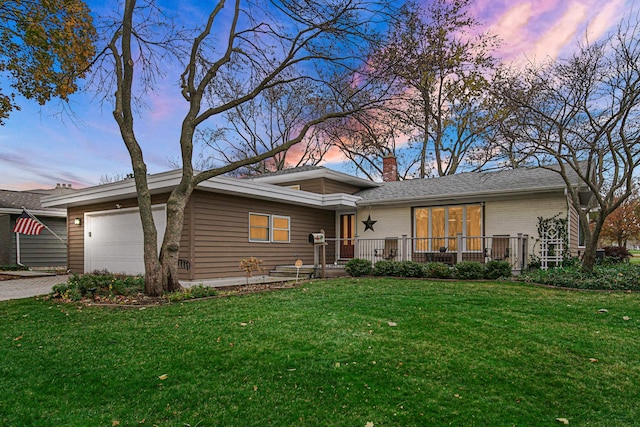 view of front of property featuring a yard and a garage