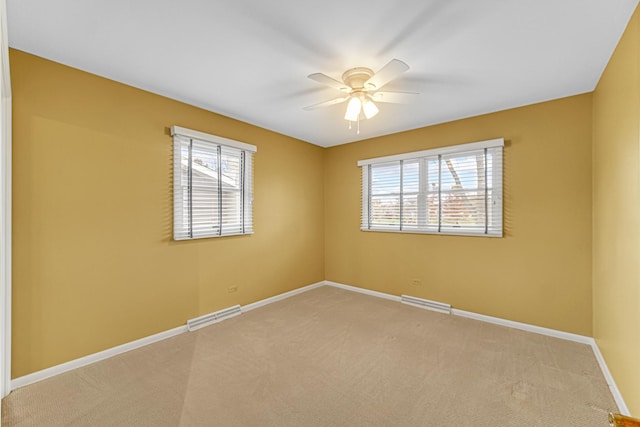 carpeted spare room with ceiling fan