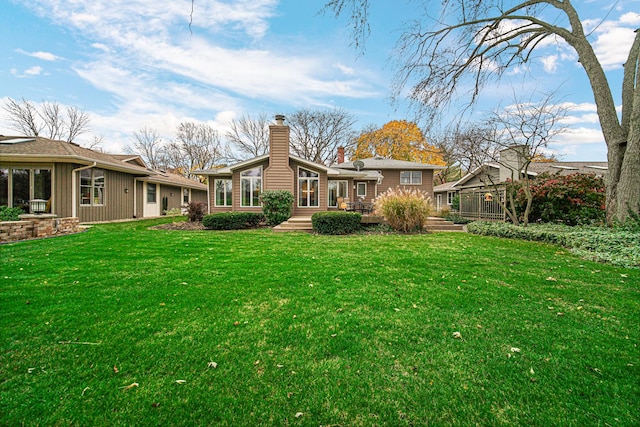 rear view of property with a yard