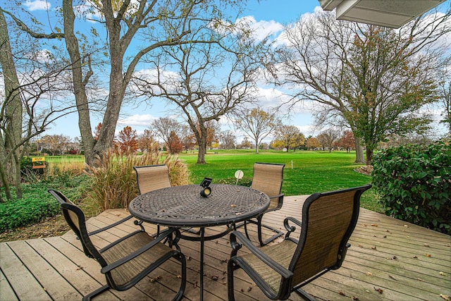 wooden deck featuring a lawn