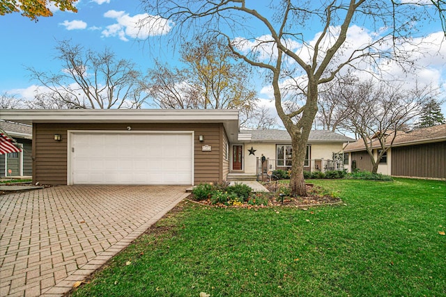 ranch-style house featuring a garage and a front yard