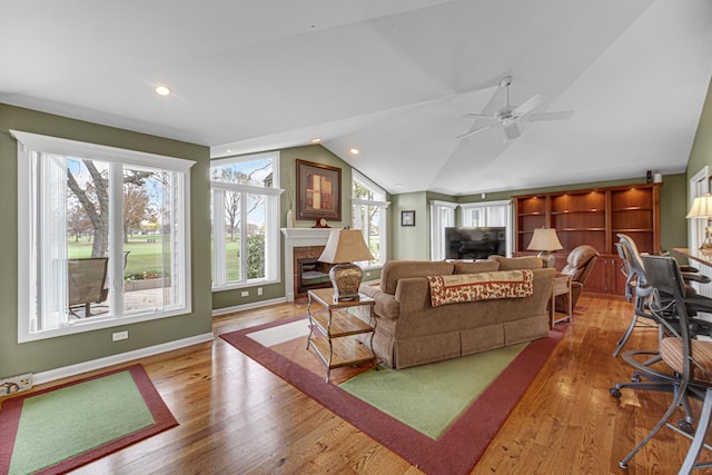 living room with lofted ceiling, plenty of natural light, and light hardwood / wood-style floors