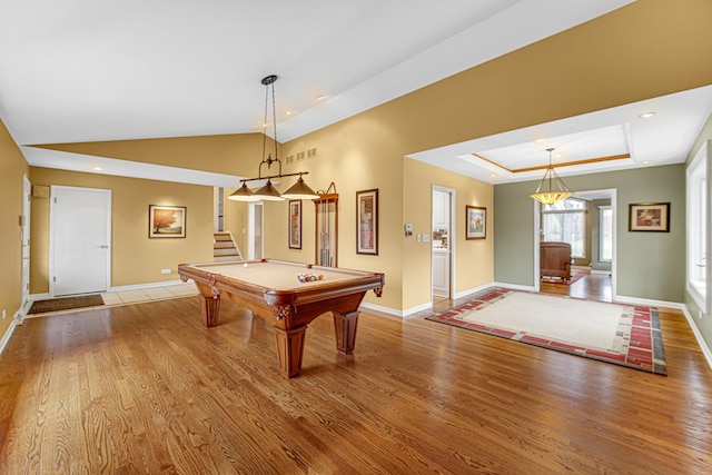 playroom with lofted ceiling, pool table, light hardwood / wood-style floors, and a raised ceiling