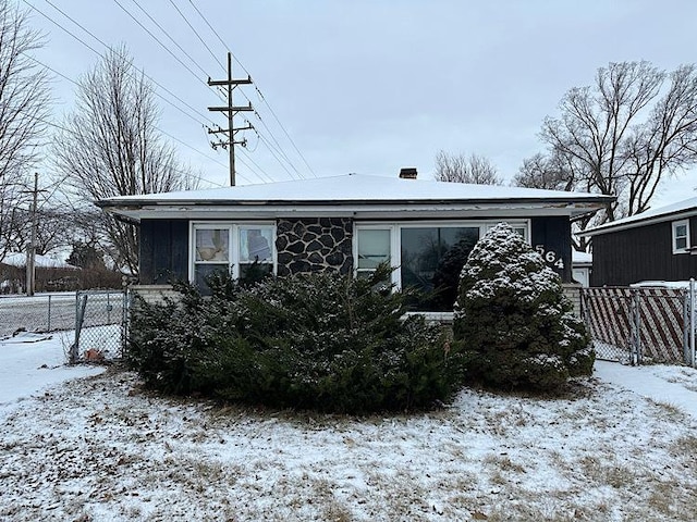 view of snow covered back of property