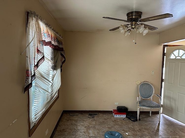 foyer entrance featuring ceiling fan