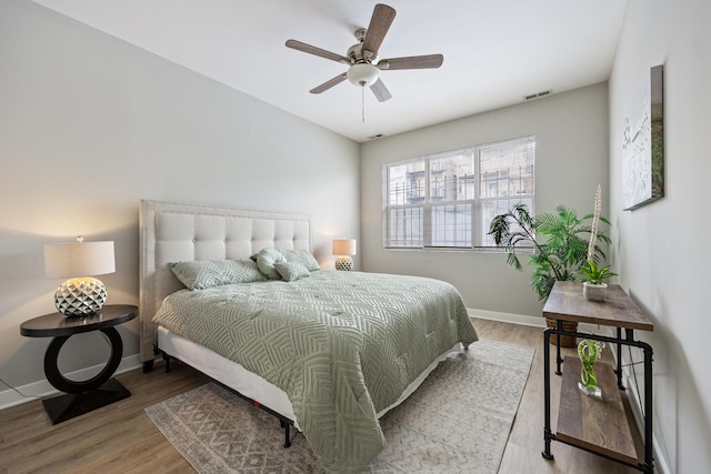 bedroom with hardwood / wood-style floors and ceiling fan