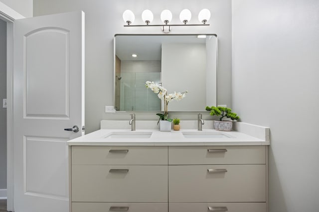 bathroom with vanity and a shower with door