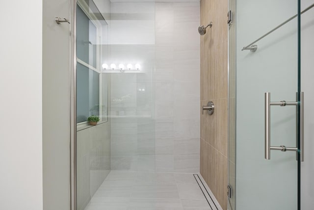 bathroom with tile patterned flooring and a shower with shower door