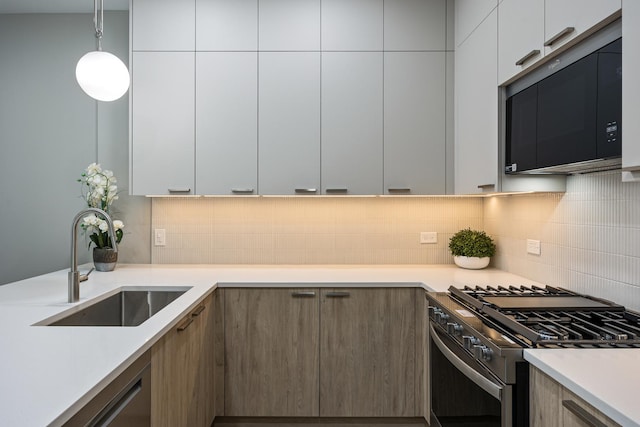 kitchen featuring white cabinets, decorative light fixtures, sink, and black appliances