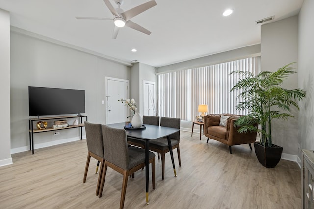 dining space featuring ceiling fan and light wood-type flooring