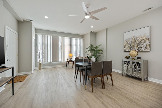 dining room with light hardwood / wood-style floors and ceiling fan