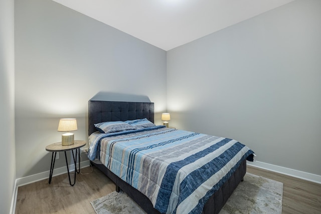 bedroom with hardwood / wood-style flooring