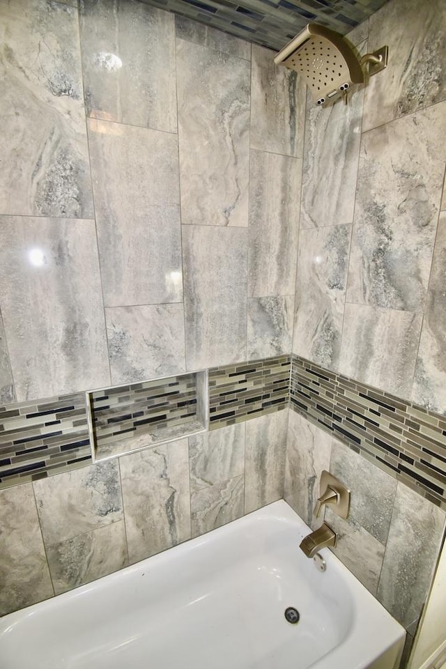 bathroom with washtub / shower combination