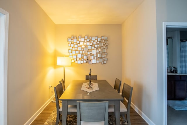 dining space with dark wood-type flooring