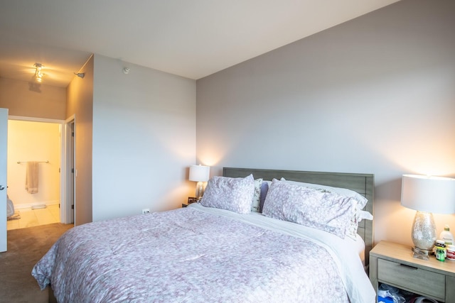 carpeted bedroom featuring ensuite bathroom