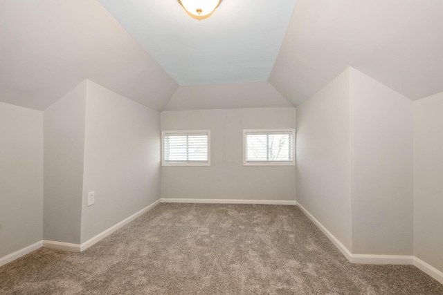 bonus room featuring lofted ceiling and light colored carpet