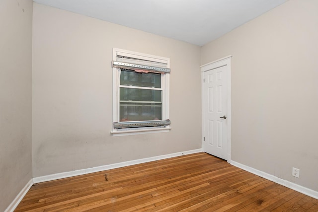 spare room with wood-type flooring