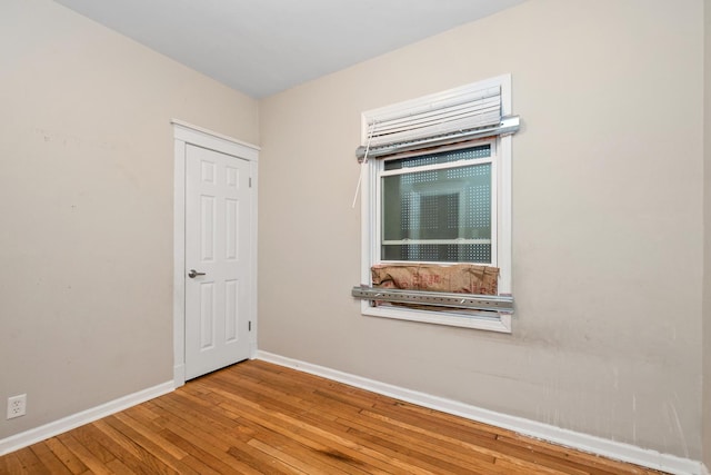 unfurnished room with hardwood / wood-style flooring