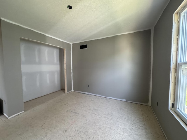 interior space featuring a textured ceiling and visible vents