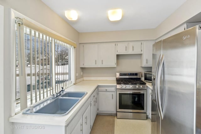 kitchen featuring white cabinetry, appliances with stainless steel finishes, and sink