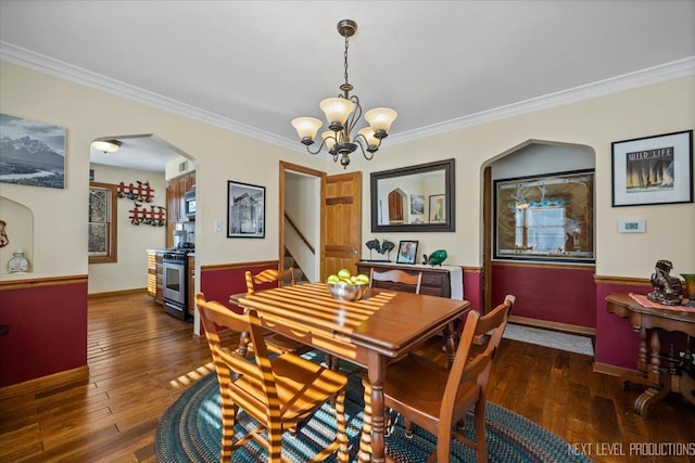 dining room featuring hardwood / wood-style flooring, arched walkways, and crown molding