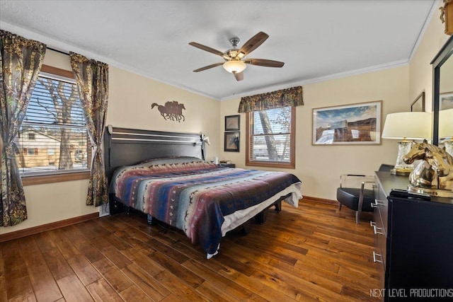 bedroom featuring baseboards, a ceiling fan, hardwood / wood-style flooring, and crown molding