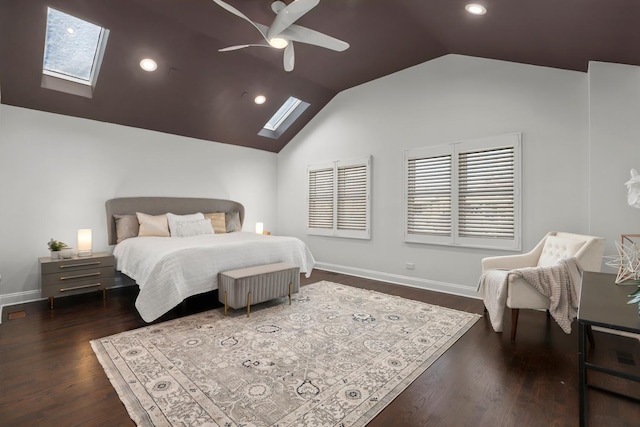 bedroom with dark hardwood / wood-style flooring, ceiling fan, and vaulted ceiling with skylight