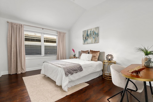 bedroom with vaulted ceiling and dark hardwood / wood-style flooring