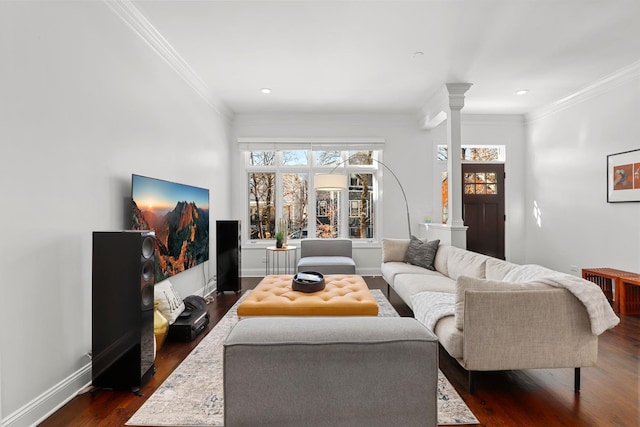 living room with dark wood-type flooring, decorative columns, and ornamental molding