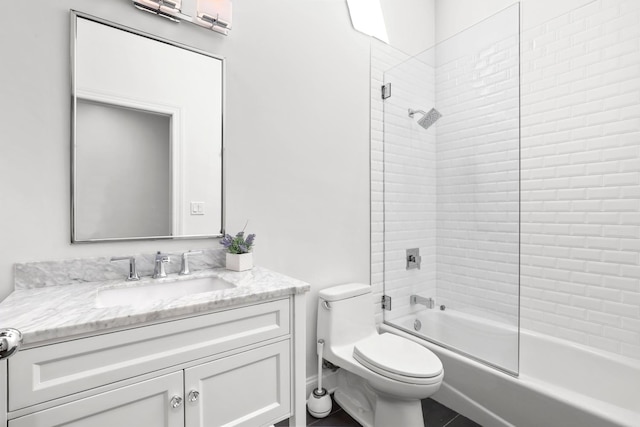 full bathroom with tiled shower / bath combo, toilet, and vanity