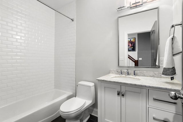 full bathroom with vanity, tiled shower / bath, and toilet