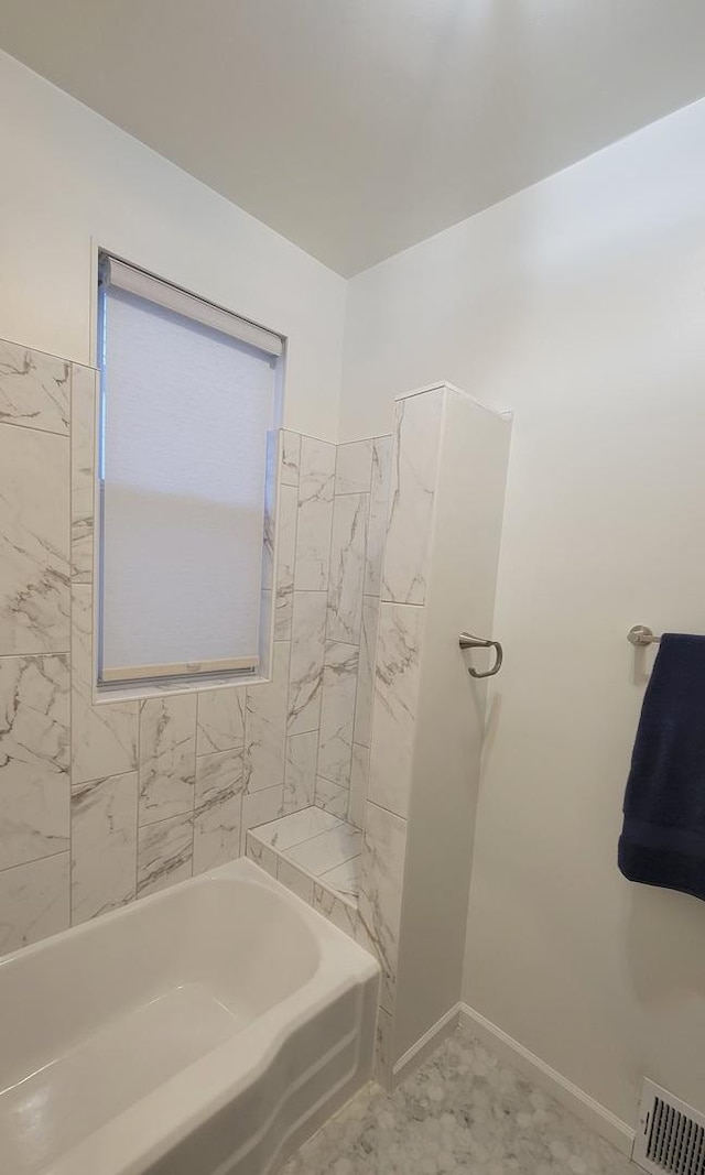 full bathroom with a bath, visible vents, and baseboards