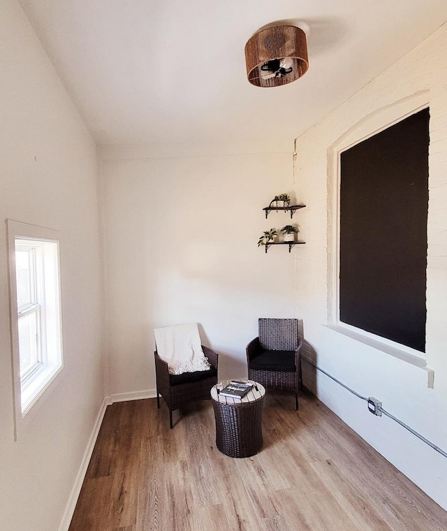 sitting room with wood finished floors and baseboards