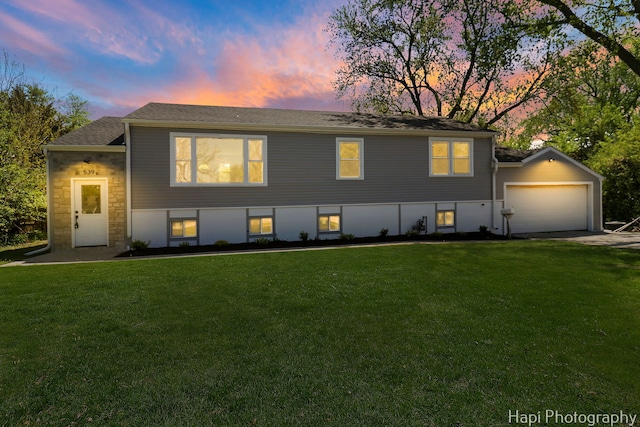 view of front of property featuring a front lawn, an attached garage, roof with shingles, stone siding, and driveway