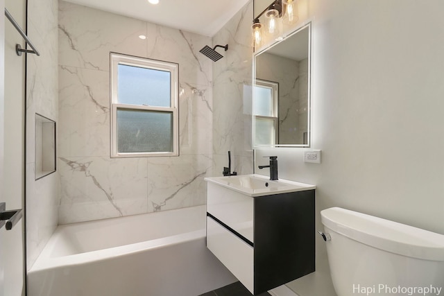 bathroom featuring plenty of natural light, toilet, vanity, and bathing tub / shower combination