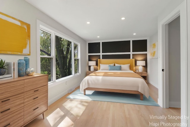 bedroom featuring baseboards, light wood finished floors, and recessed lighting