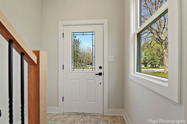 doorway to outside featuring baseboards