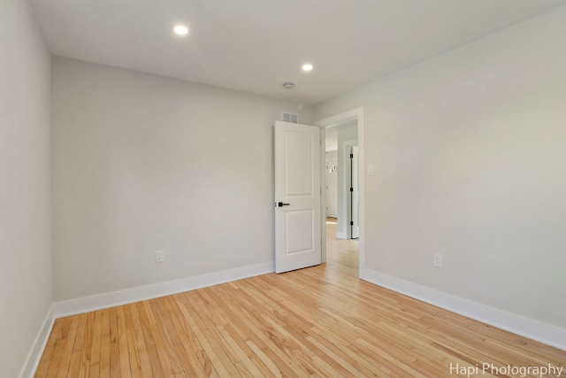 spare room with light wood-style flooring, baseboards, and recessed lighting