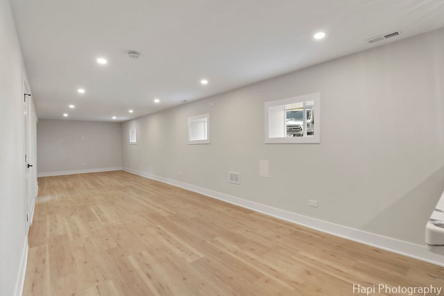 below grade area with recessed lighting, light wood finished floors, and baseboards